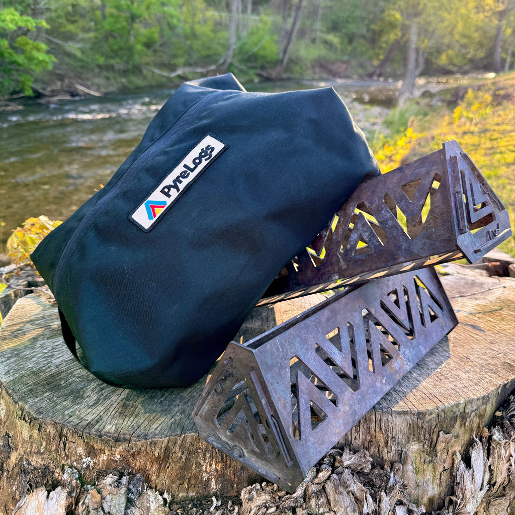 Black bag with a logo and metal tools on a tree stump by a river
