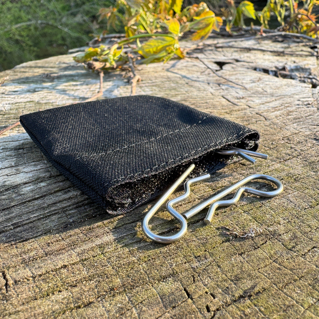 Black pin bag on a wooden surface