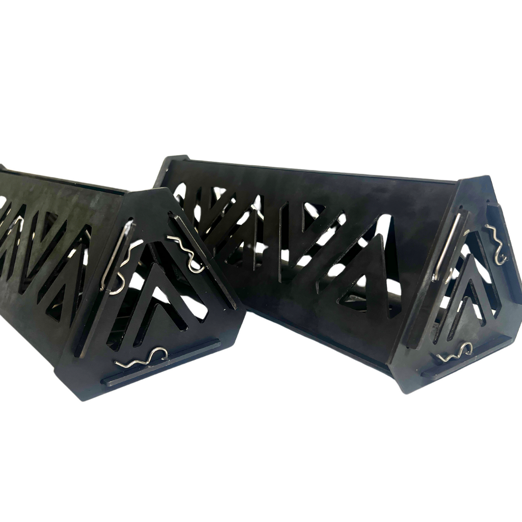 Two black metal PyreLogs on a white background